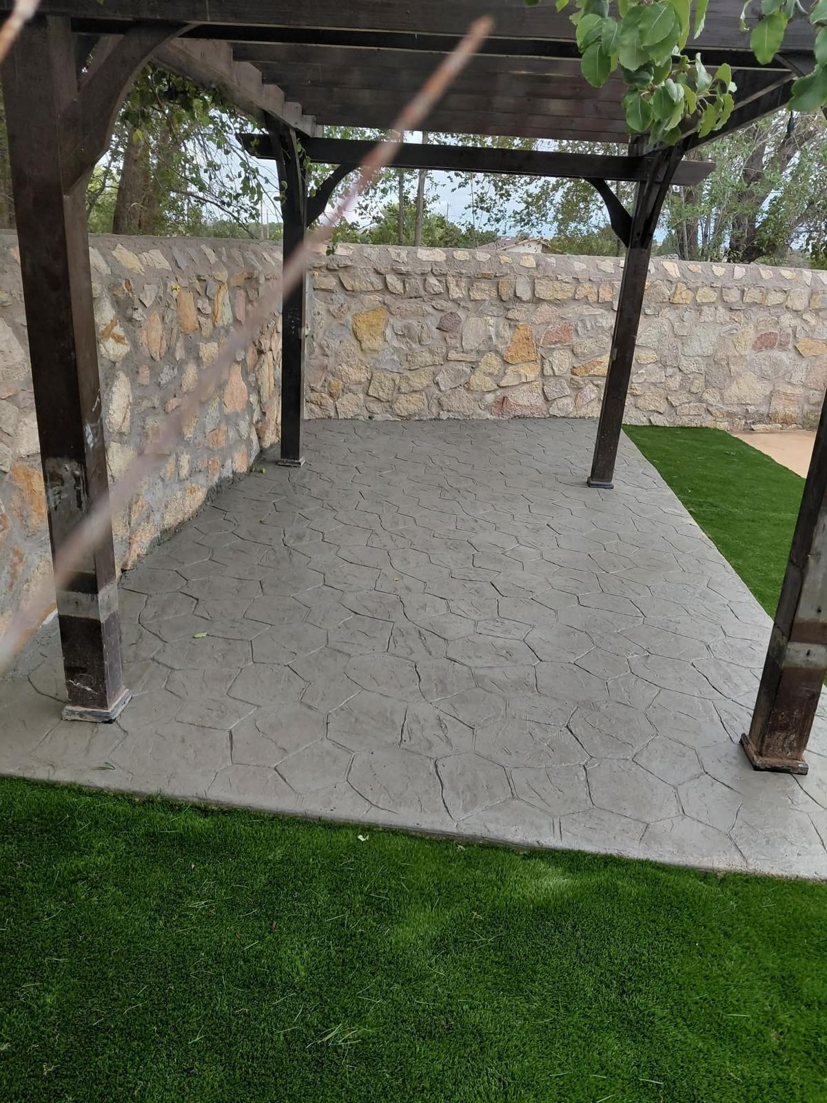 Pergola over stamped patio